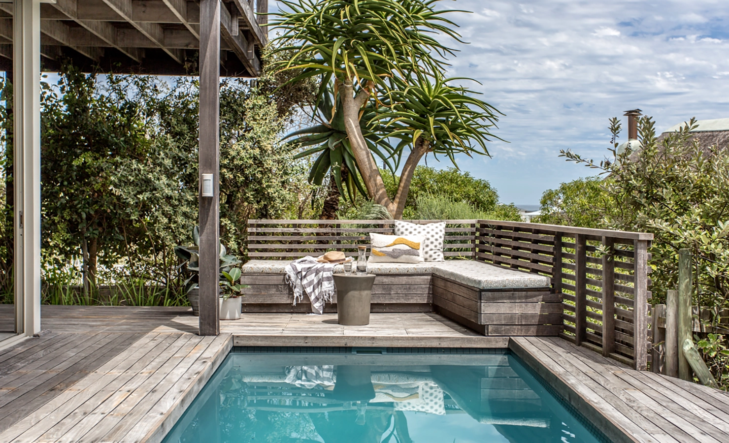 Perfect Hideaways: Outdoor seating area, wooden deck veranda overlooking swimming pool. White Waters, Kommetjie.
