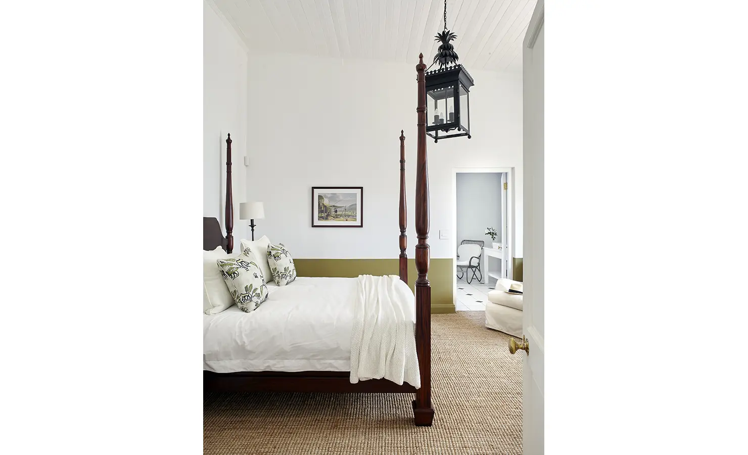 Perfect Hideaways: A cosy bedroom featuring a four-poster bed with floral cushions, natural textures, and a view into a pristine en-suite bathroom. Penhill Manor House, Nuy Valley.
