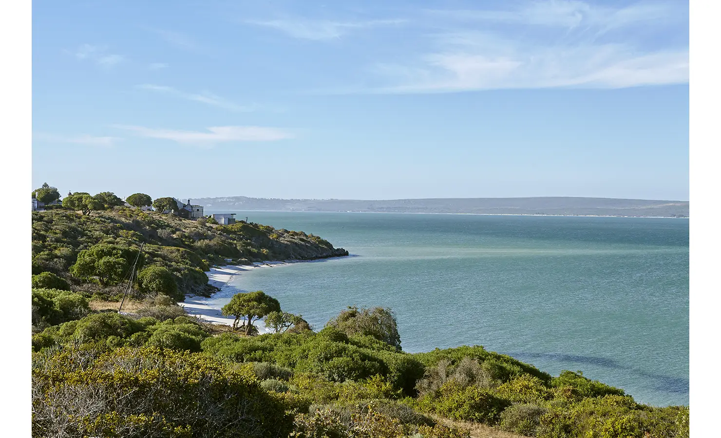 Perfect Hideaways: Panoramic view across the turquoise lagoon to white-sand coves and fynbos-clad headland under a wide blue sky. Seagull Cottage, Churchhaven.