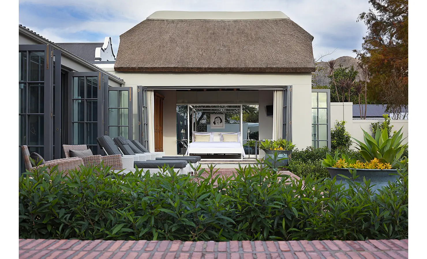 Open plan thatch cottage leading out to patio and garden. Koko House.
