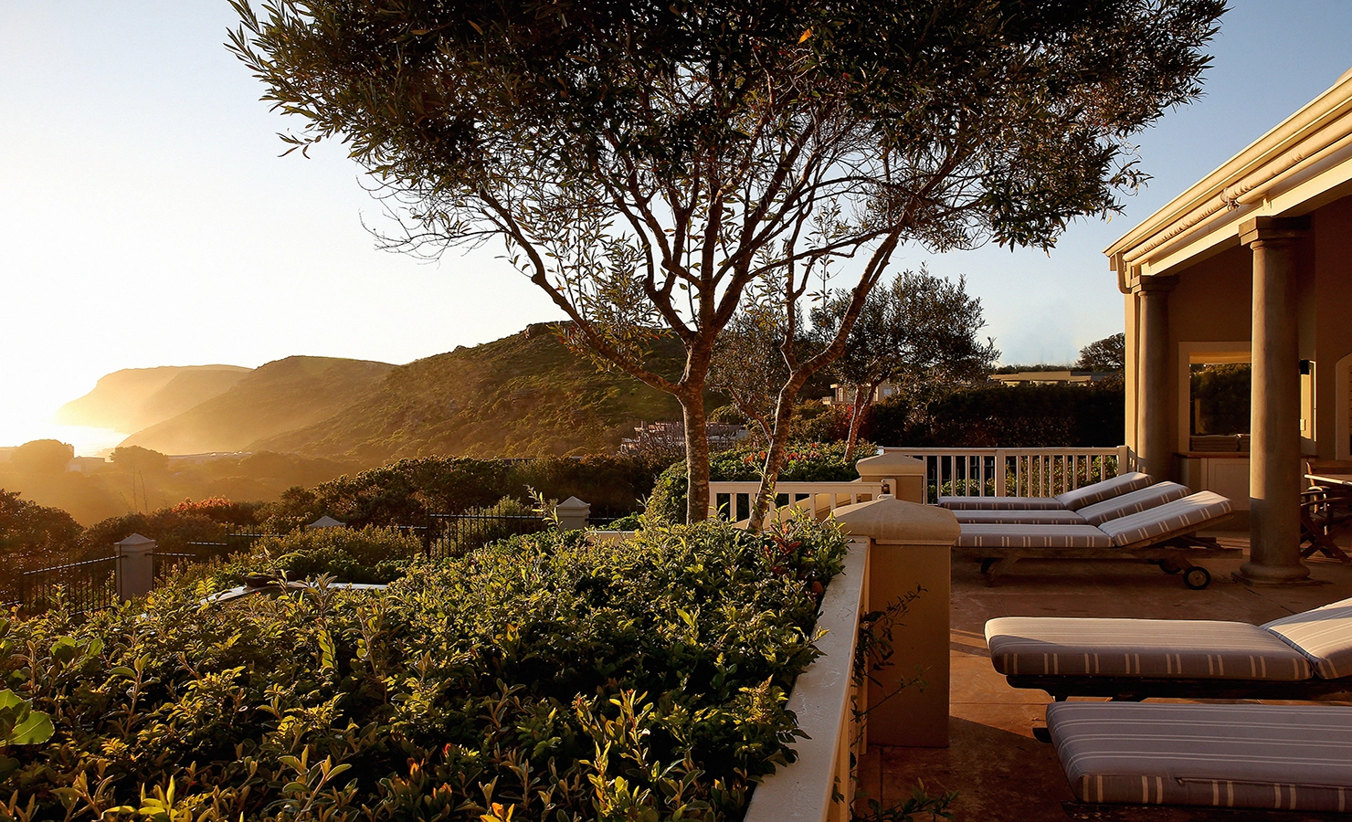 Perfect Hideaways: A rustic yet elegant kitchen with a large island, vintage lanterns, and open shelving, creating a homely atmosphere. Beachwood On Robberg, Plettenberg Bay.