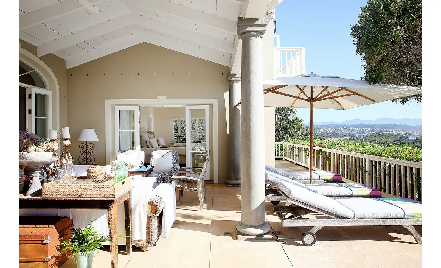 Perfect Hideaways: A bright and inviting outdoor space with sun loungers, a shaded seating area, and views of the distant hills and ocean under a clear blue sky. Beachwood On Robberg, Plettenberg Bay.