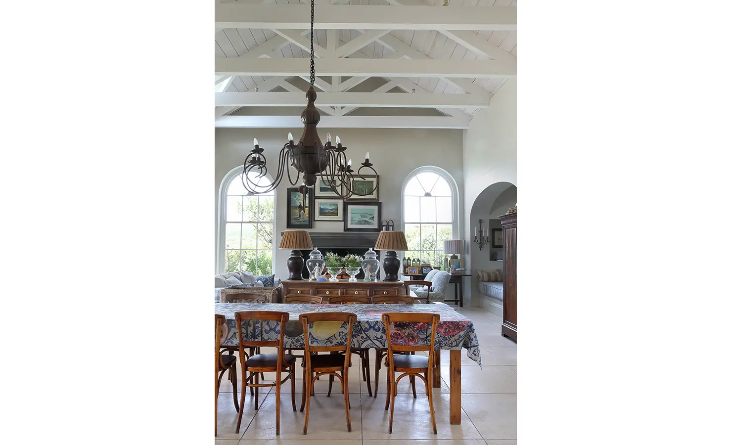 Perfect Hideaways: A dining room with exposed beam ceilings, a large rustic chandelier, and a collection of vintage-style furniture, creating a charming and sophisticated atmosphere. Beachwood On Robberg, Plettenberg Bay.
