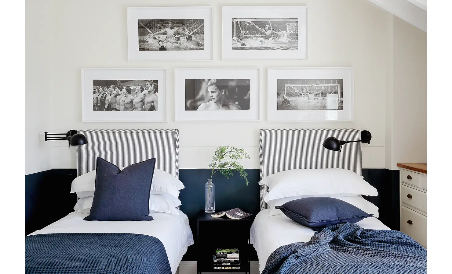 Perfect Hideaways: A modern twin bedroom with striped headboards, navy accents, and black-and-white framed photographs creating a stylish and cosy space. Beachwood On Robberg, Plettenberg Bay.