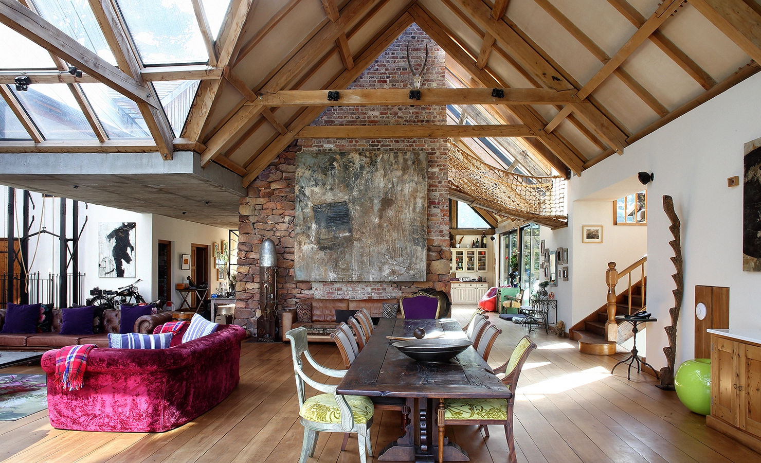 Perfect Hideaways. A large, open living room with a prominent table and chairs, ideal for family gatherings and entertaining guests. Gaia, Constantia.