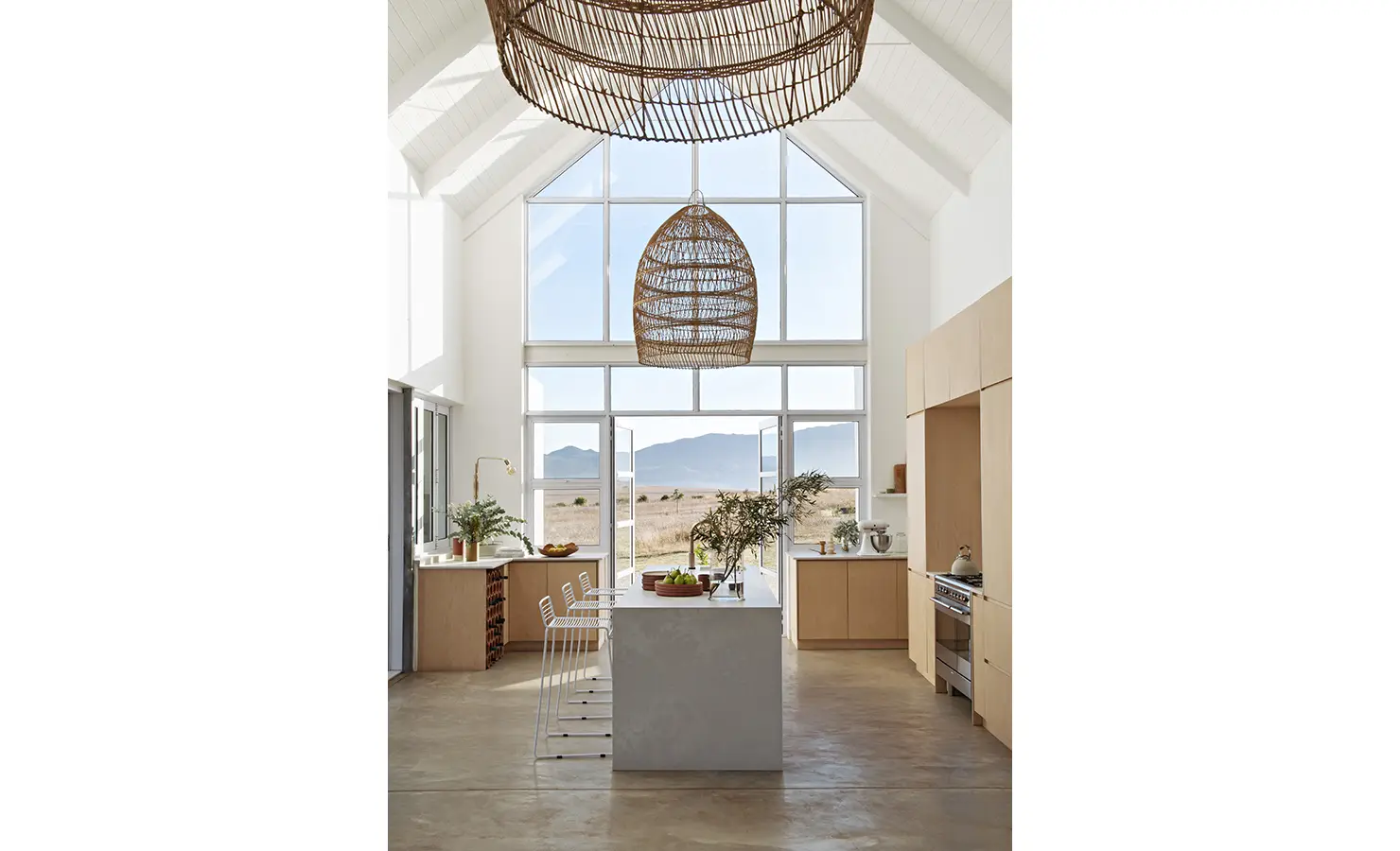Perfect Hideaways: Double-volume kitchen with natural wood cabinetry, central island, and mountain views framed by full-height windows, Thuúla Haven, Hemel-en-Aarde.