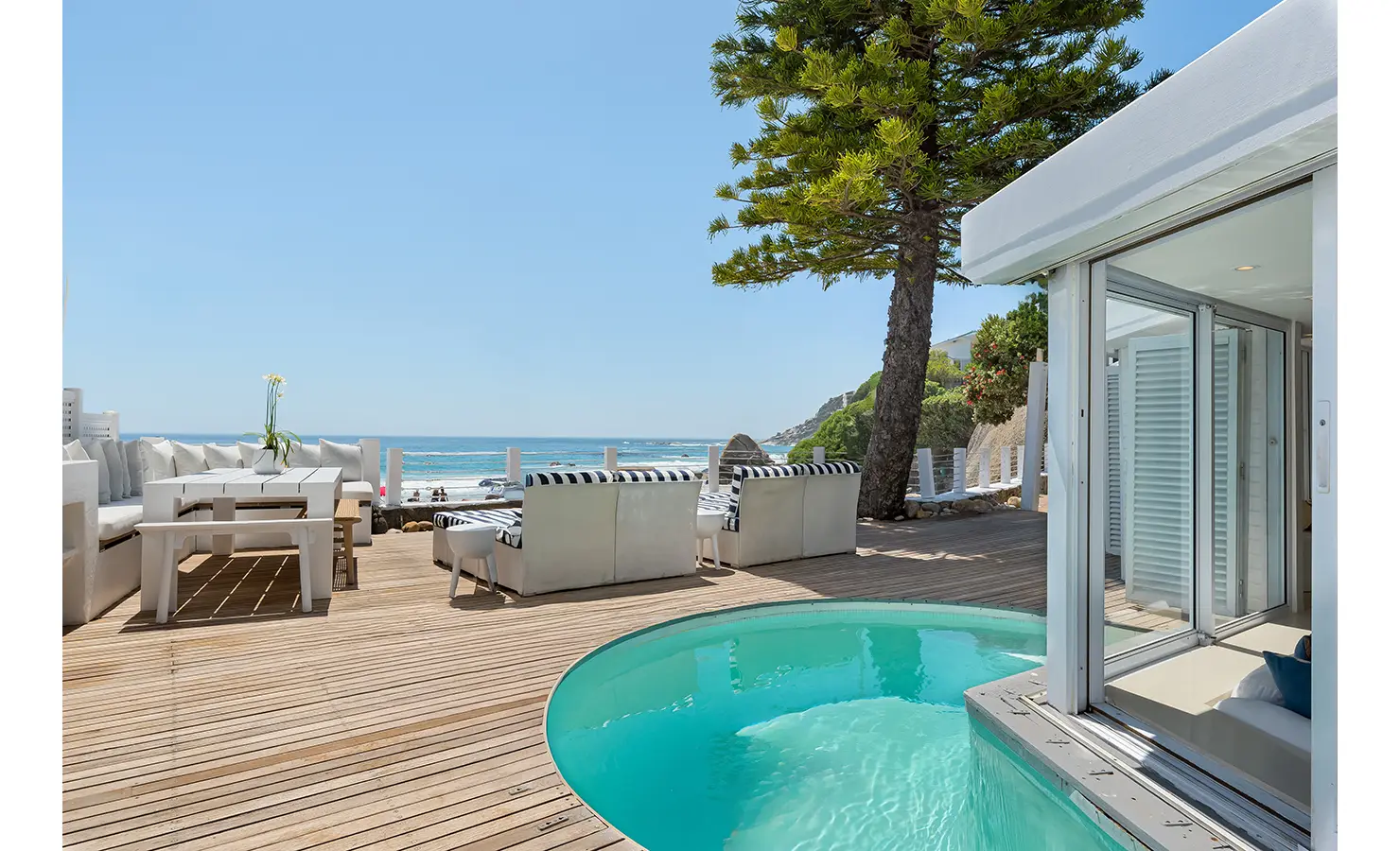 Perfect Hideaways private deck with plunge pool and striped loungers overlooking Clifton beach and turquoise ocean views, Clifton Sands, Clifton