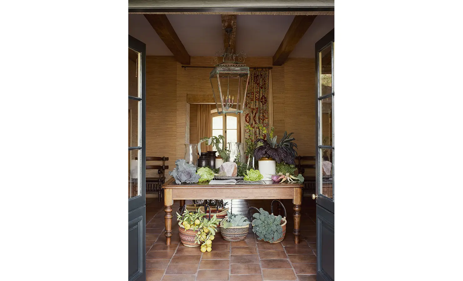 Perfect Hideaways: A charming indoor display of fresh vegetables and greenery atop a wooden table, surrounded by rustic décor. Sterrekopje, Franschhoek.