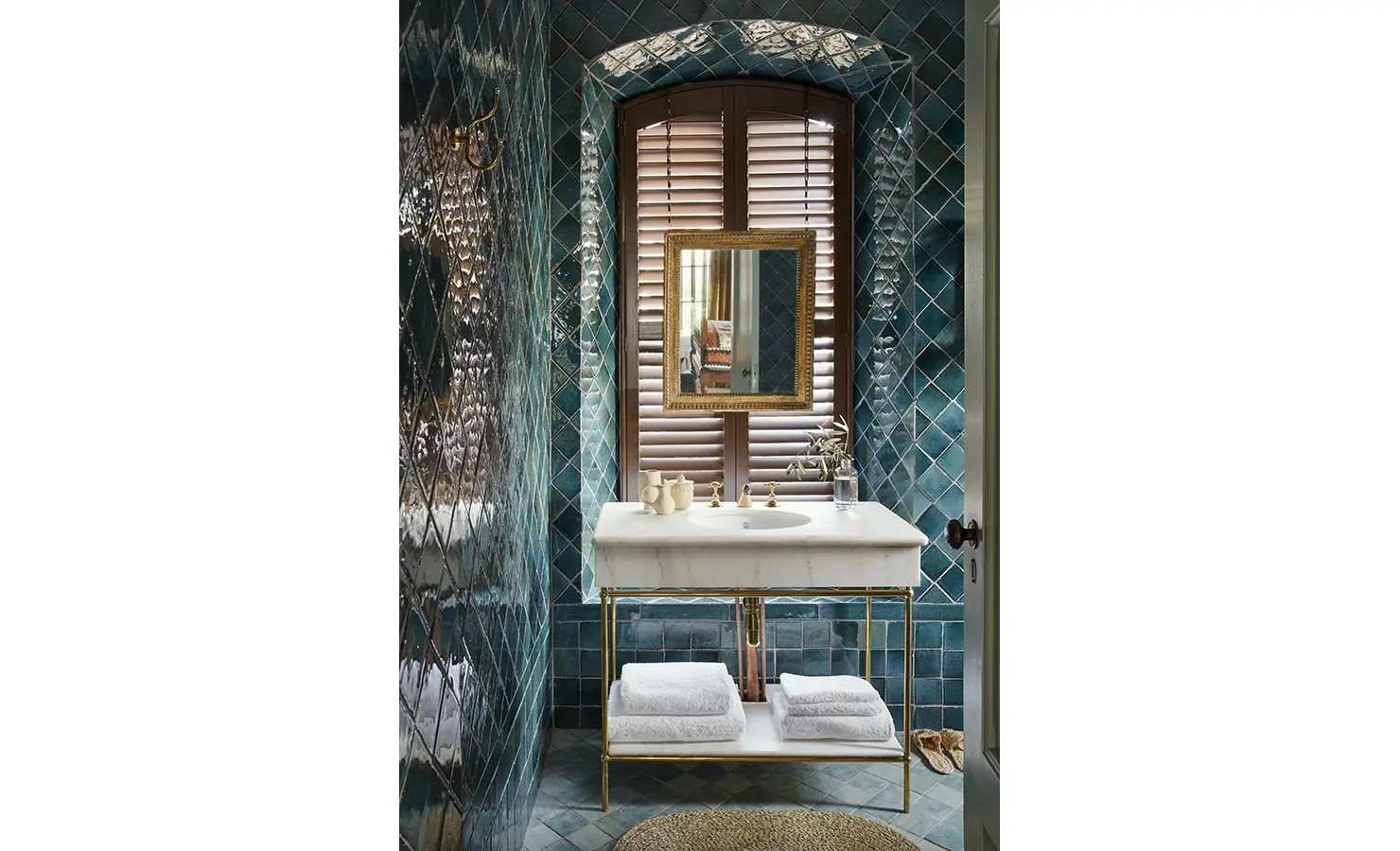 Perfect Hideaways: A stylish bathroom with deep teal tiles, a marble vanity, and a large mirror reflecting warm natural light. Sterrekopje, Franschhoek.