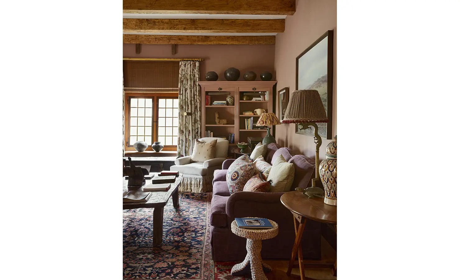 Perfect Hideaways: A library-inspired sitting room with built-in shelves, a plush sofa, and a collection of patterned cushions. Sterrekopje, Franschhoek.