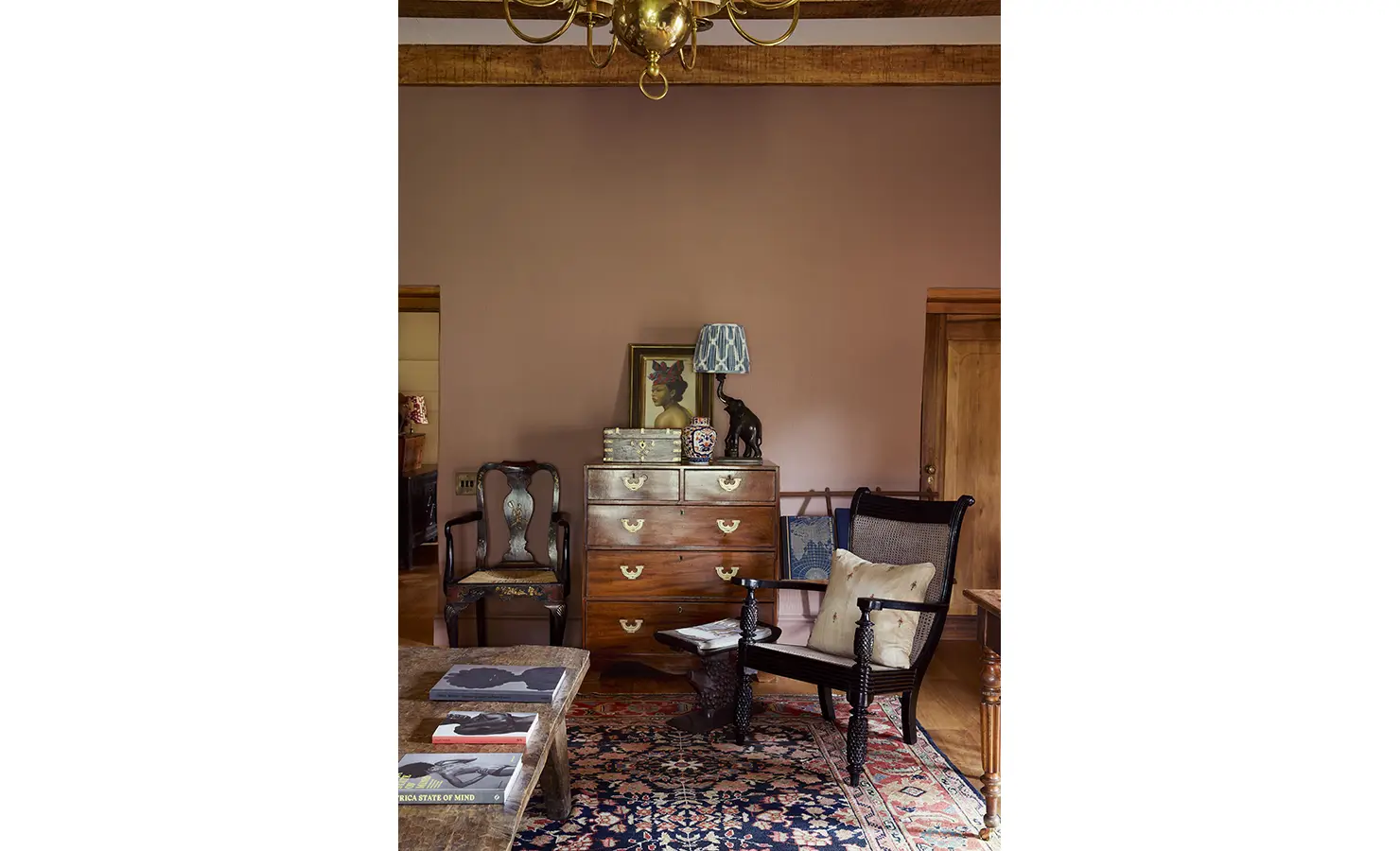 Perfect Hideaways: A charming corner with a vintage wooden chest of drawers, a classic armchair, and ornate decorative pieces. Sterrekopje, Franschhoek.