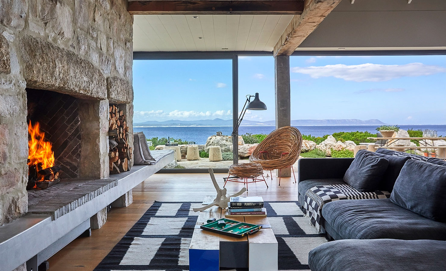 The fireplace and living room at Stone House in Hermanus, overlooking Walker Bay