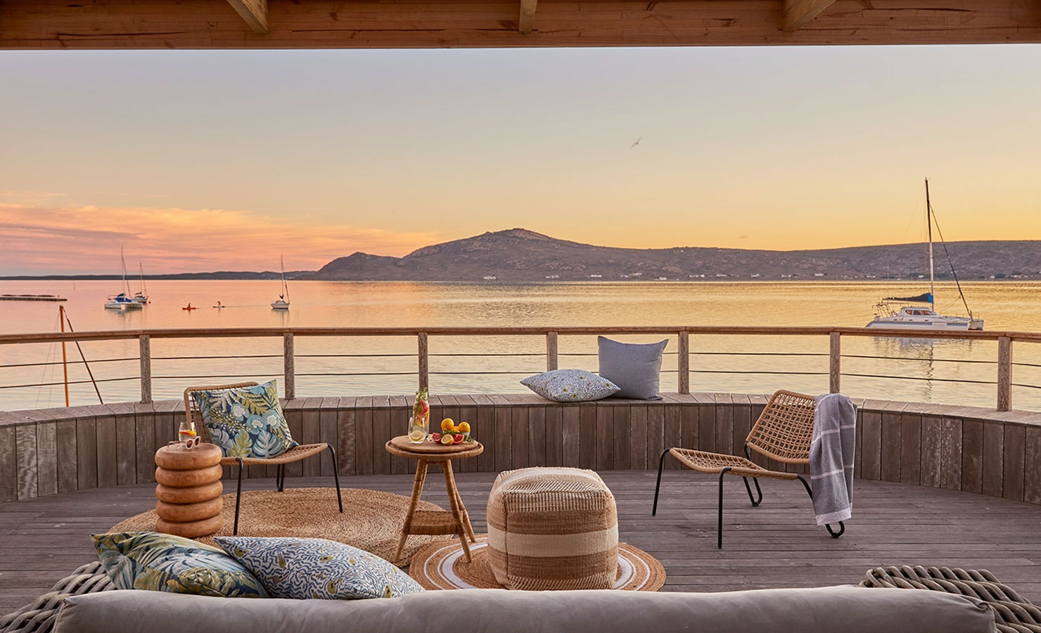 Summer sunsets are long and languid on the Langebaan lagoon: time for sundowners on the deck