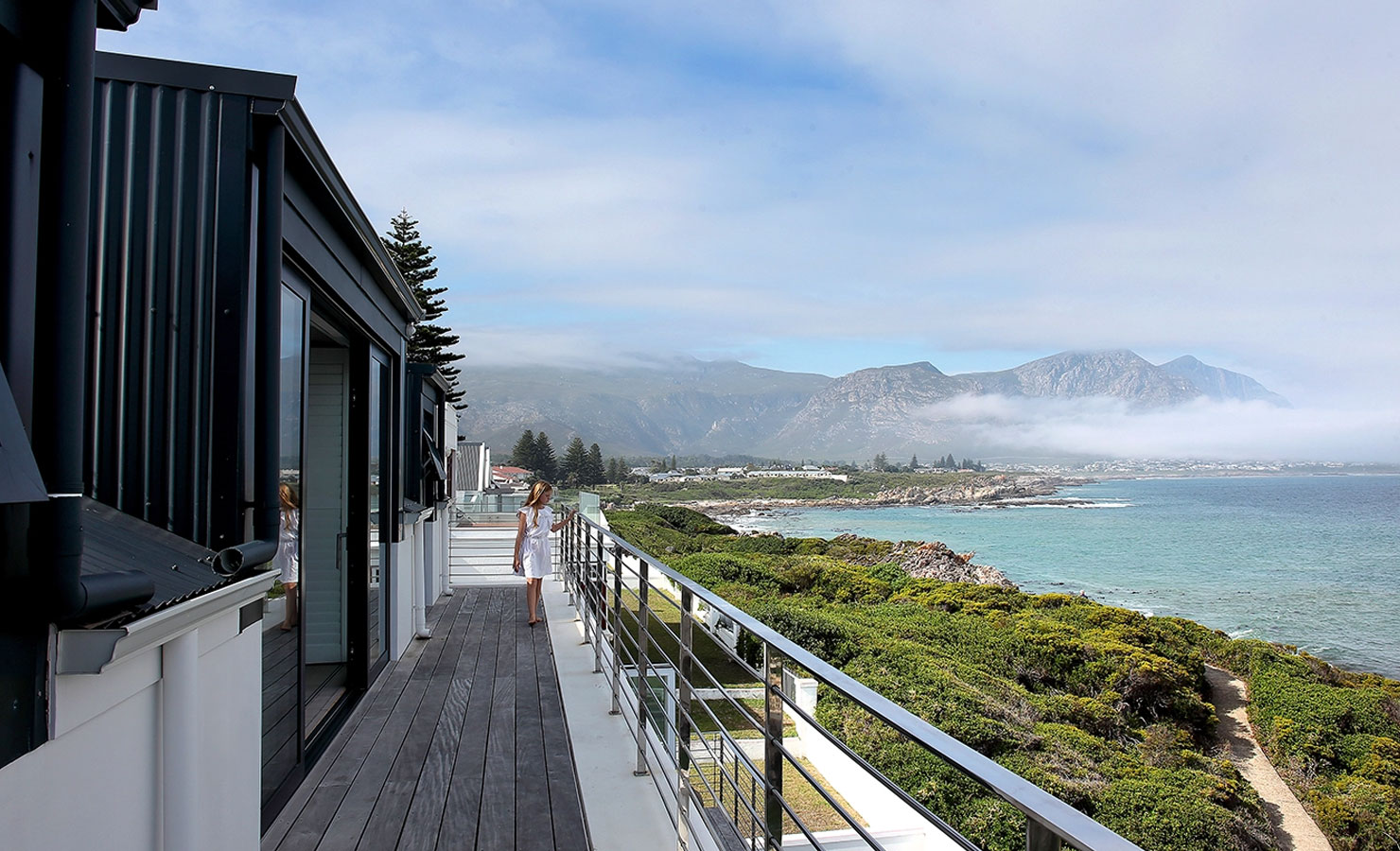 The upper balcony of The Blue Anchor has a beautiful view out over the cliffside path with its rocky coves and tidal pools, extending all along the Hermanus coast with its dramatic Overberg mountains and pristine beaches lining Walker Bay.