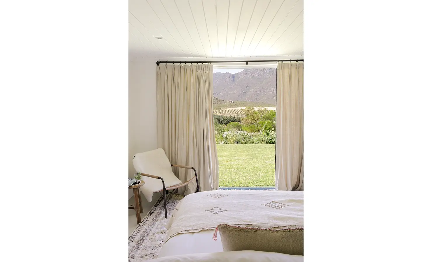 View from spacious bed with double doors exposing view of the Buchubos villa garden.