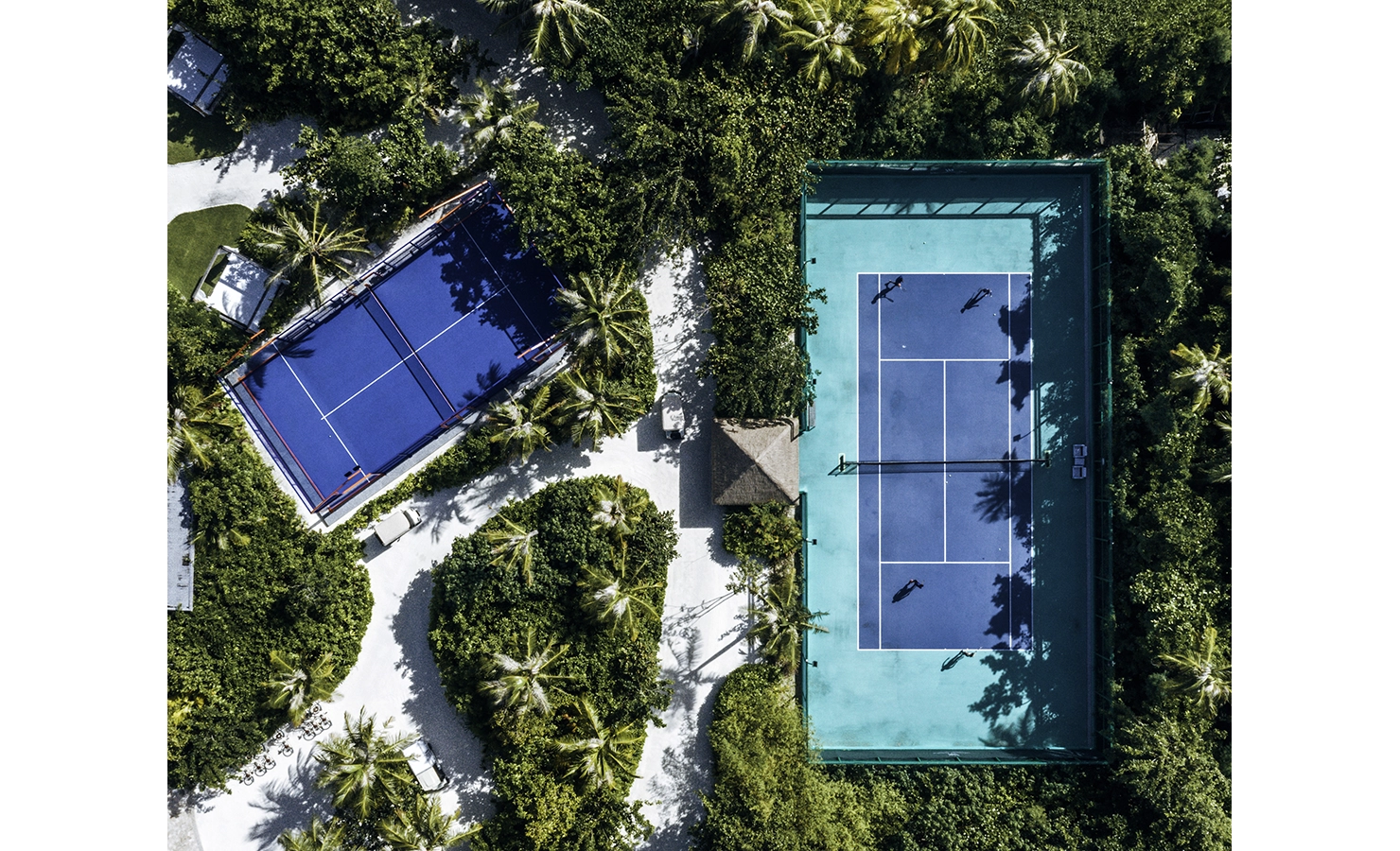 Perfect Hideaways, Waldorf Maldives, Luxury accommodation aerial view of tennis court surrounded by greenery