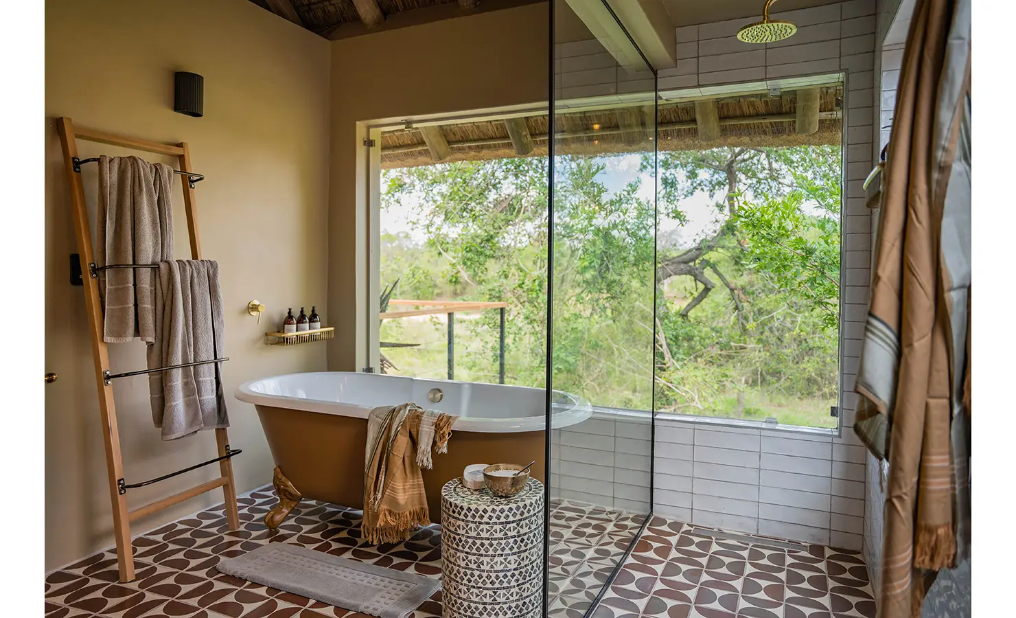Perfect Hideaways: A private deck with woven armchairs and a bamboo screen, nestled among lush greenery. The perfect spot for a morning coffee while taking in the tranquillity of the bush. Thornybush Lodge, Thornybush Game Reserve.