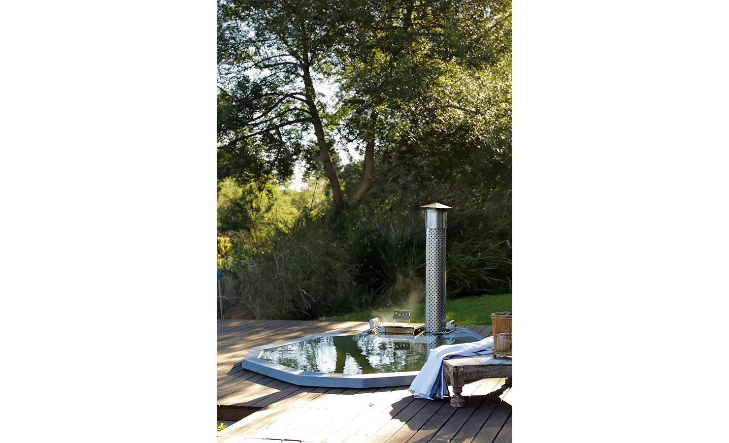 Perfect Hideaways: Outdoor wood-fired hot tub on a timber deck surrounded by trees and nature. Stonehaven House, Hemel-en-Aarde.