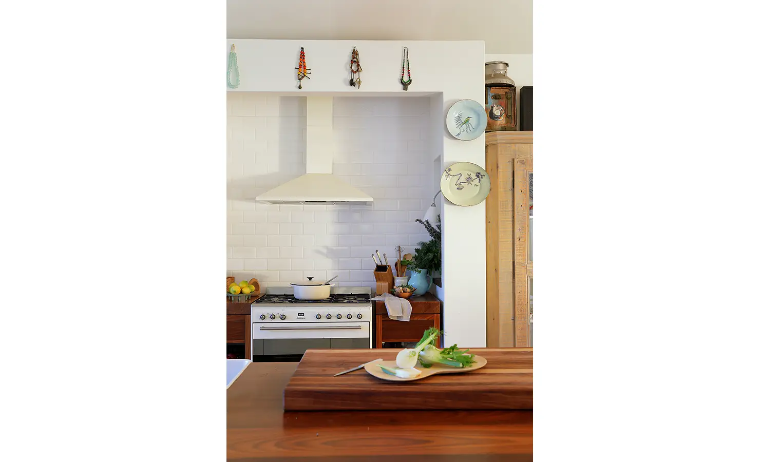 Perfect Hideaways: Bright, airy kitchen with white cabinetry, rustic wood finishes, and eclectic decorative touches. Stonehaven House, Hemel-en-Aarde.