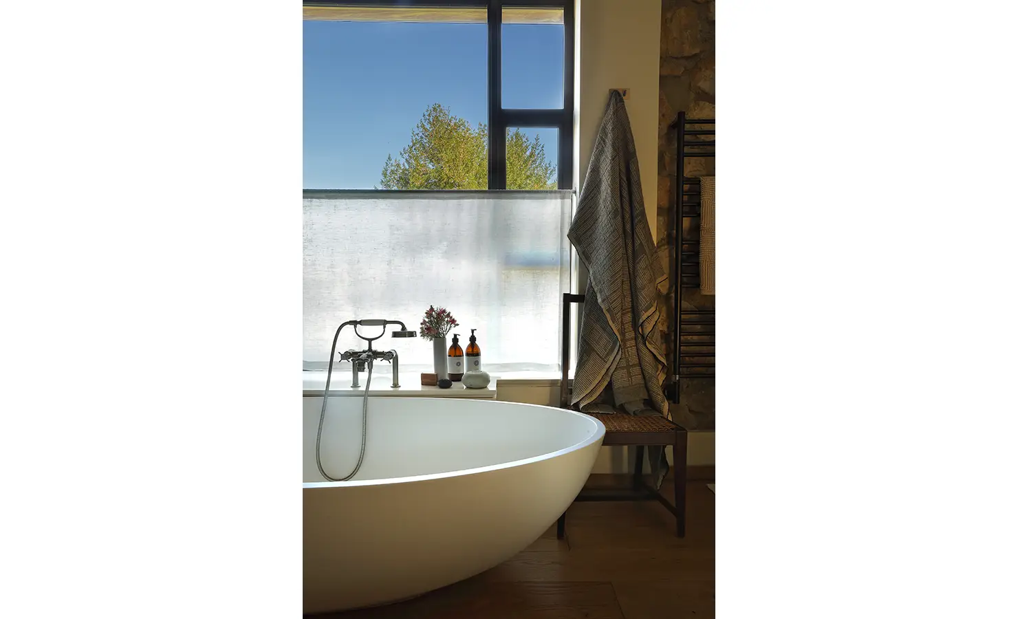 Perfect Hideaways: Freestanding bathtub set beside a large window with garden and mountain views. Stonehaven House, Hemel-en-Aarde.