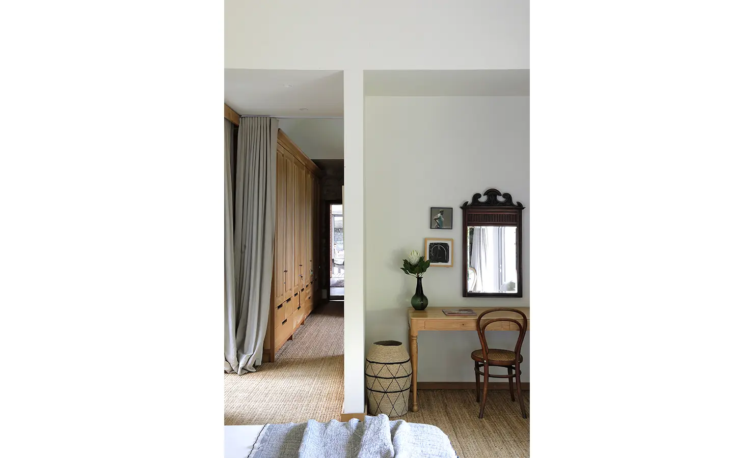 Perfect Hideaways: Bedroom corner with writing desk, woven chair, and antique mirror beside a walk-through wardrobe. Stonehaven House, Hemel-en-Aarde.