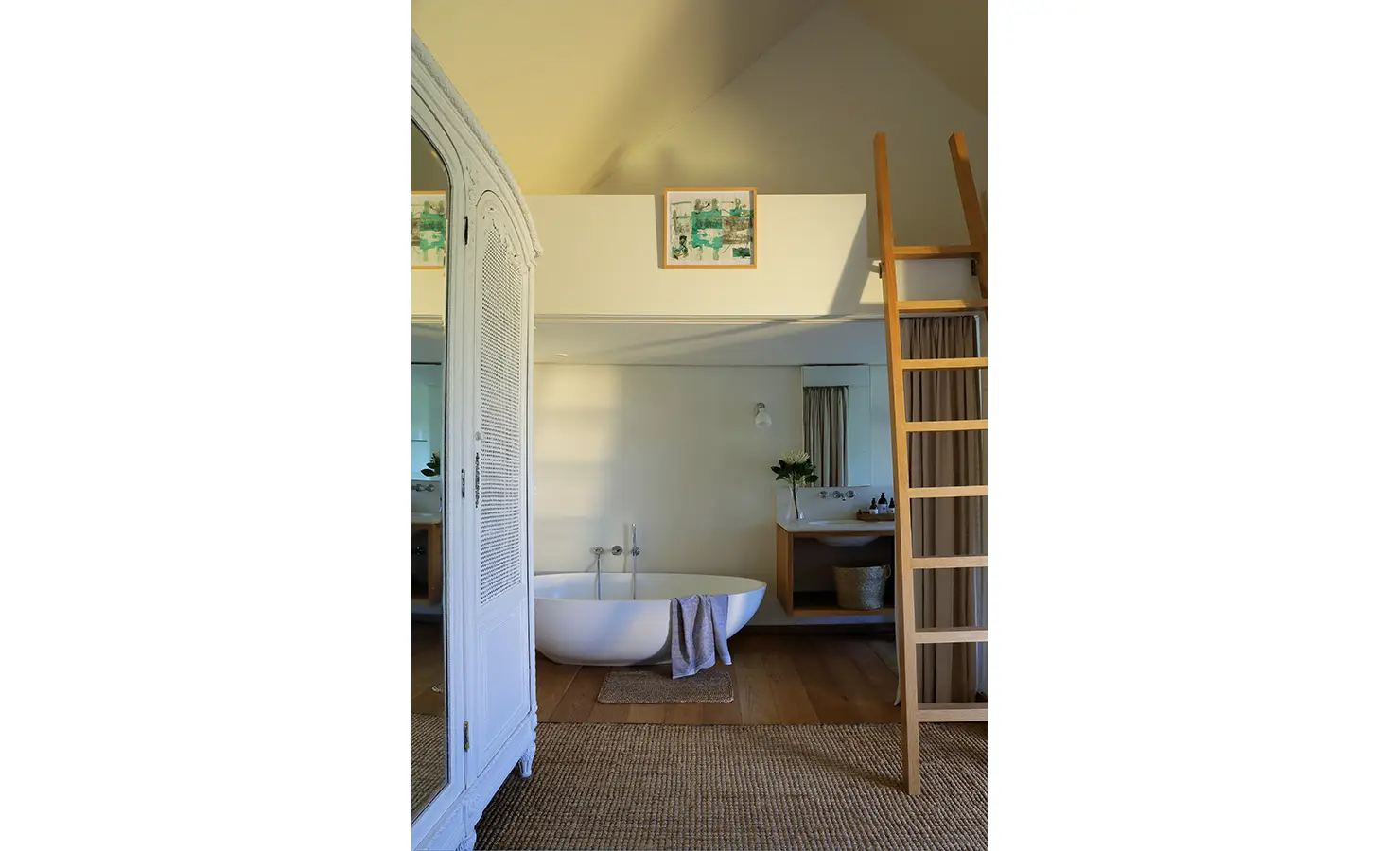 Perfect Hideaways: Loft-style room with freestanding bathtub, wooden ladder, and a large wardrobe with mirrored doors. Stonehaven House, Hemel-en-Aarde.
