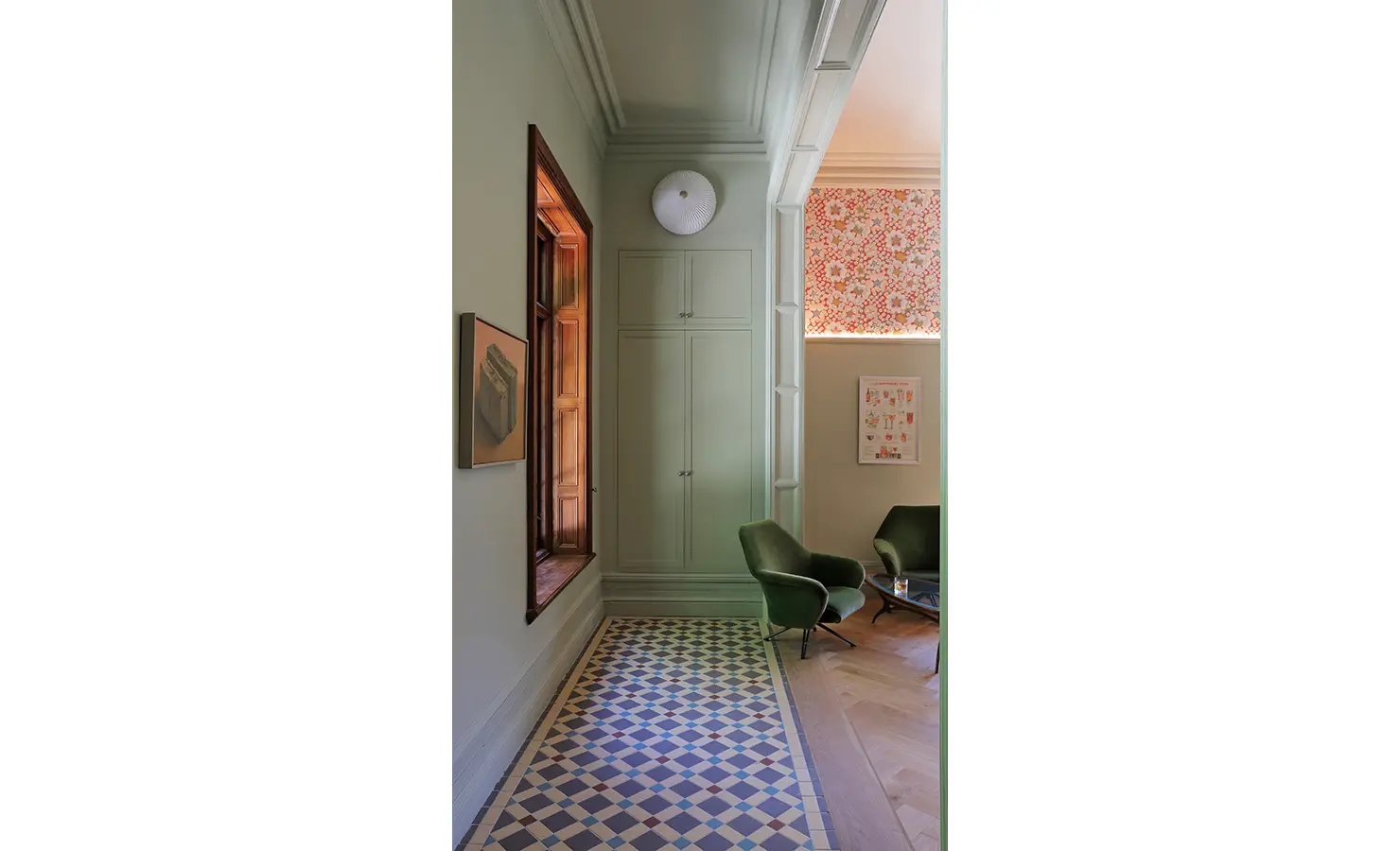 Perfect Hideaways — A serene hallway with patterned floor tiles and muted green walls leading into a cozy sitting nook. Mid-century armchairs and floral patterned blinds lend warmth and personality. Bishopscourt, Bishops Hall.