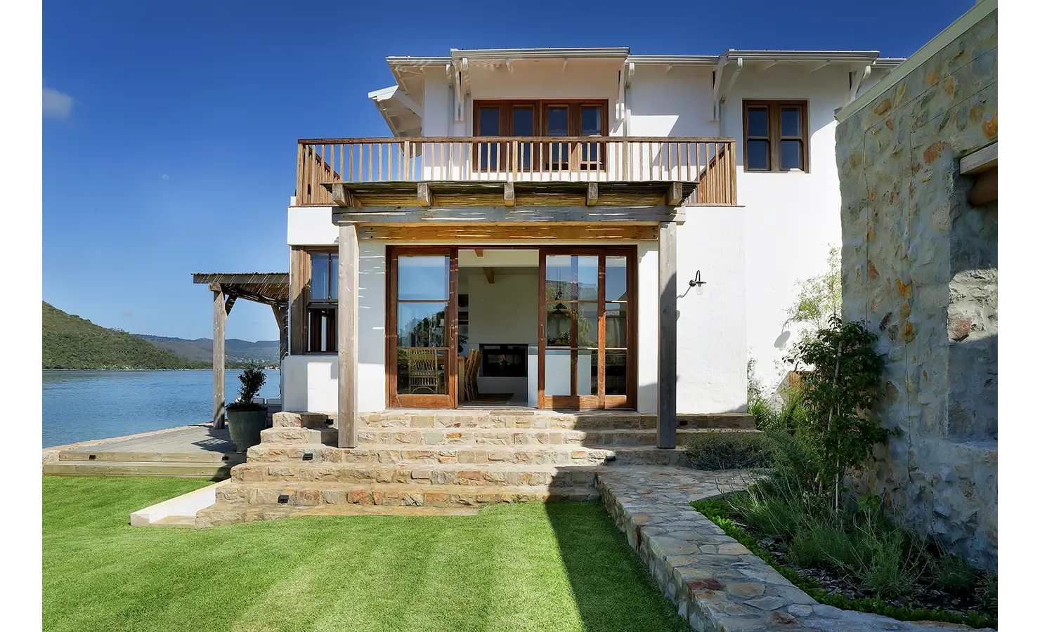 Perfect Hideaways: Waterfront home with stone steps, timber-framed doors and a broad balcony opening to the lagoon, Knysna, Tides Reach