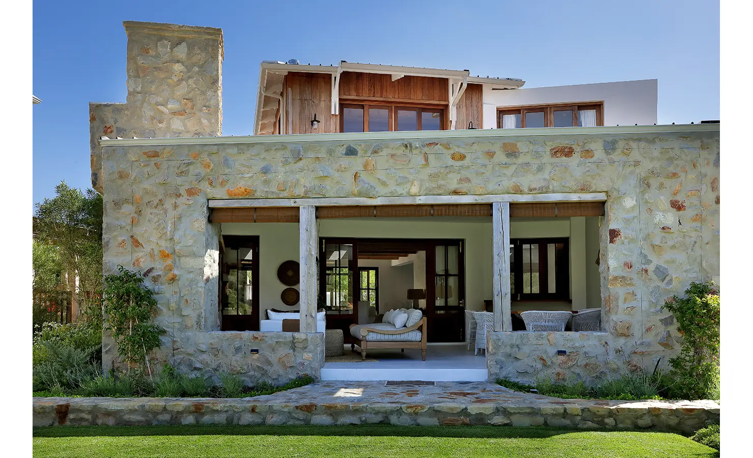Perfect Hideaways: Stone-clad veranda with deep openings to relaxed living and dining areas, set above a neat lawn, Knysna, Tides Reach