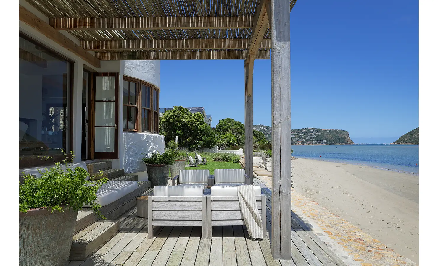 Perfect Hideaways: Pergola-shaded deck with cushioned seating opening directly onto the sandy lagoon beach, Knysna, Tides Reach