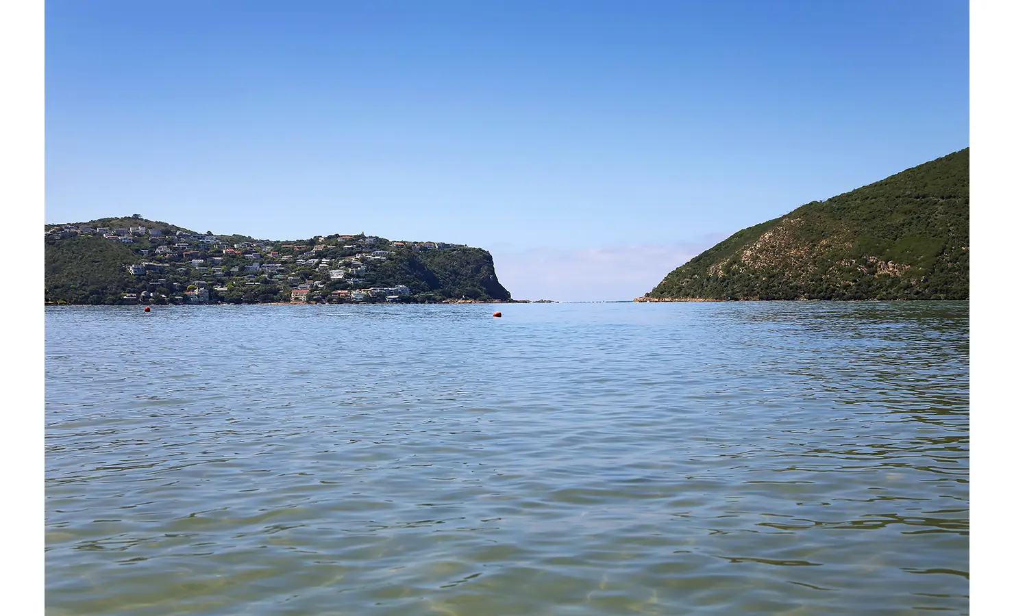 Perfect Hideaways: Wide view across the calm lagoon towards the Knysna Heads between forested cliffs, Knysna, Tides Reach
