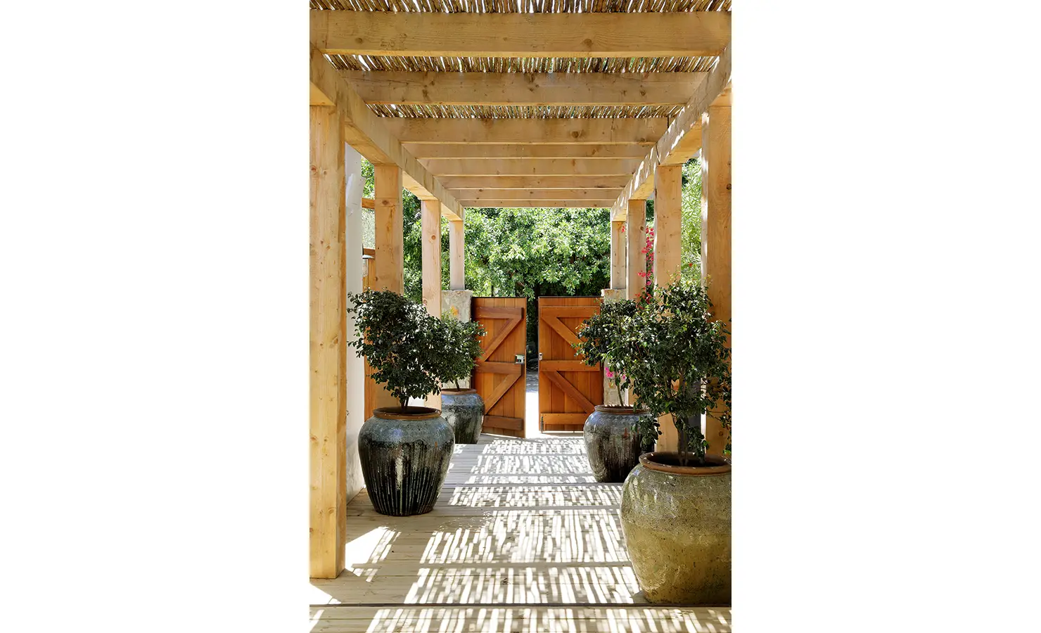 Perfect Hideaways: Timber pergola entrance with dappled shade, oversized ceramic pots and double wooden gates, Knysna, Tides Reach