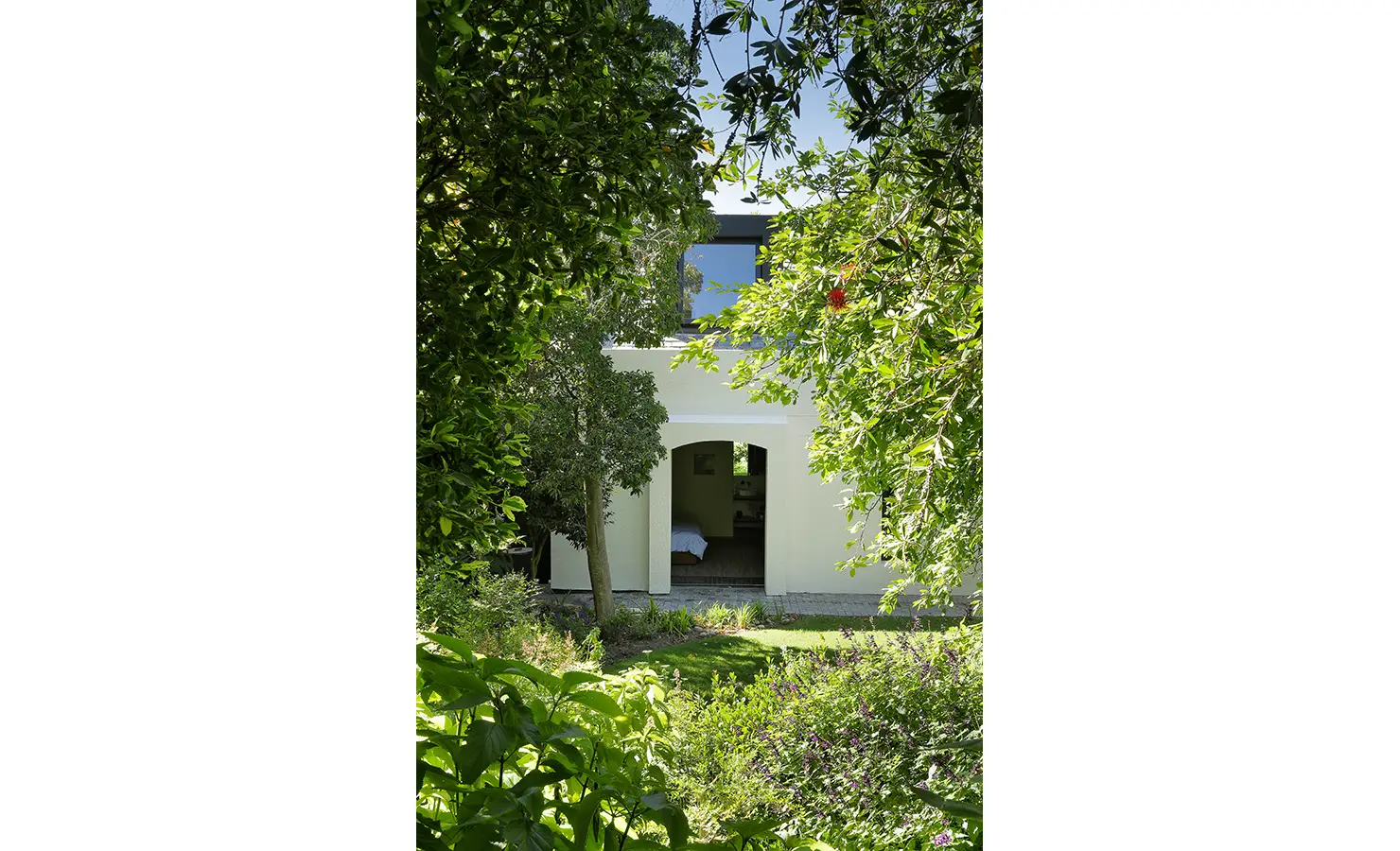 Perfect Hideaways: leafy garden view framing a white archway leading into a serene bedroom, Franschhoek, The Garden House