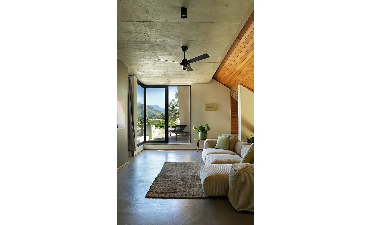 Perfect Hideaways: calm upper lounge with deep sofa, concrete and timber ceilings, and doors opening to mountain views, Franschhoek, The Garden House