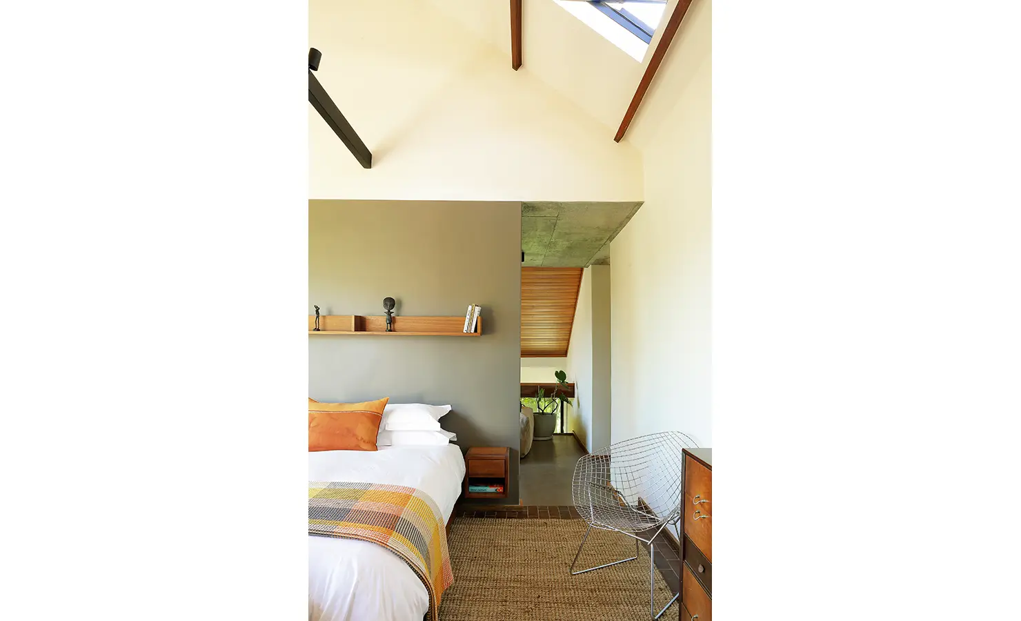 Perfect Hideaways: bright bedroom with vaulted ceiling, skylight, minimalist shelf and warm timber accents, Franschhoek, The Garden House