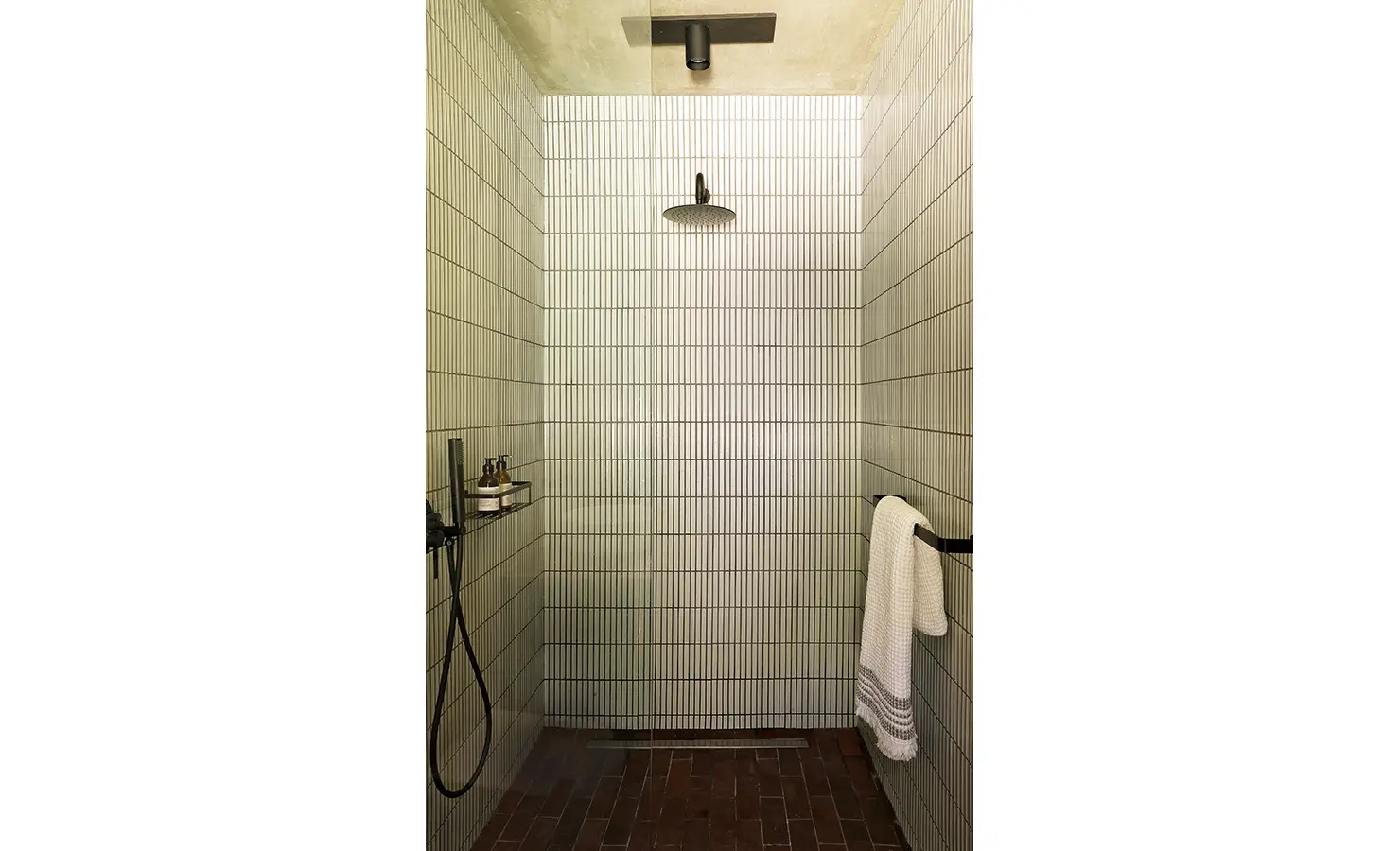 Perfect Hideaways: walk-in shower lined with slim vertical tiles, rainfall head, handheld and brick floor, Franschhoek, The Garden House