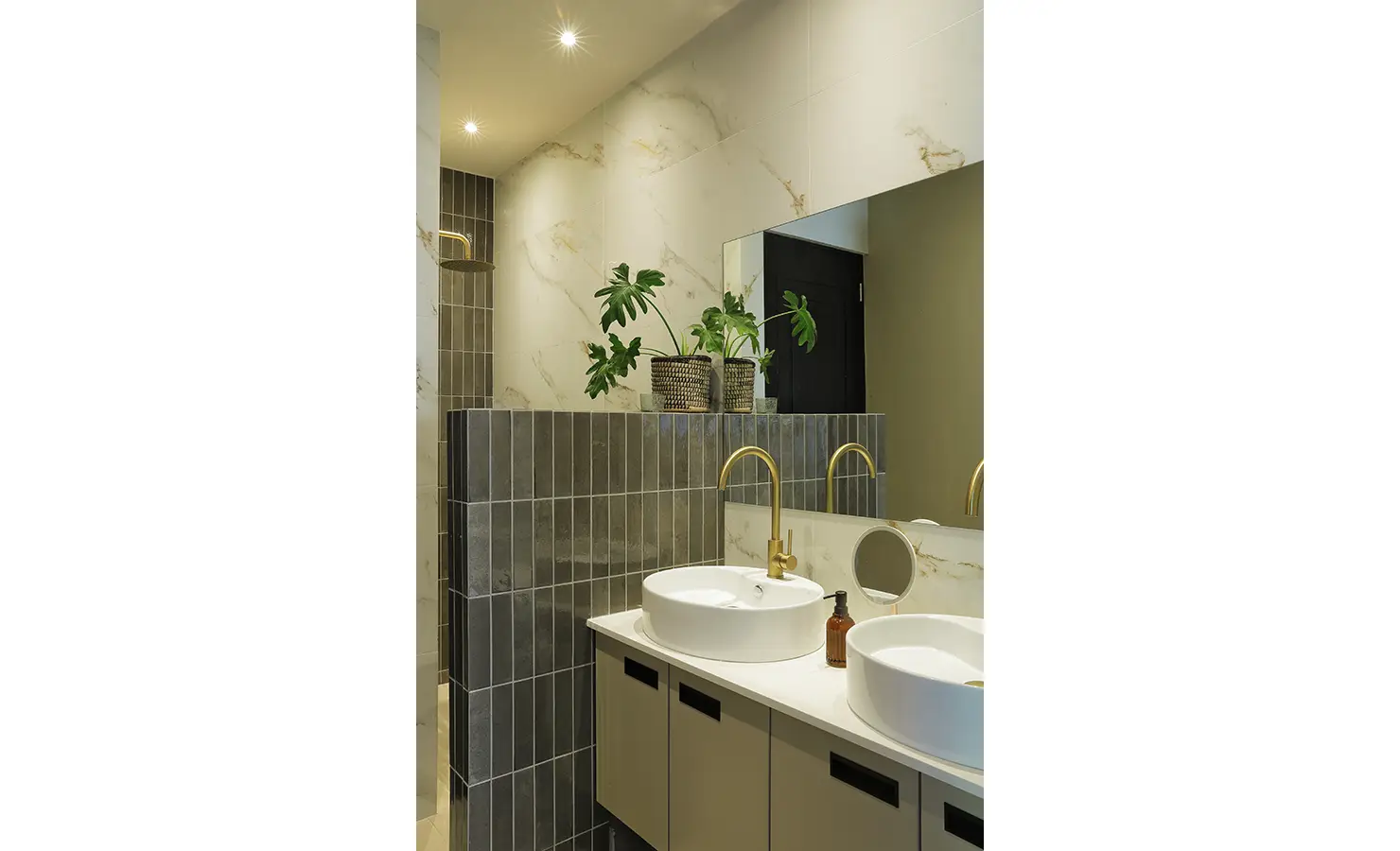 Perfect Hideaways: A luxurious bathroom with a marble and tiled finish, golden fixtures, and soft lighting that highlights elegant botanical décor. Bel Ombre Hills, Constantia.