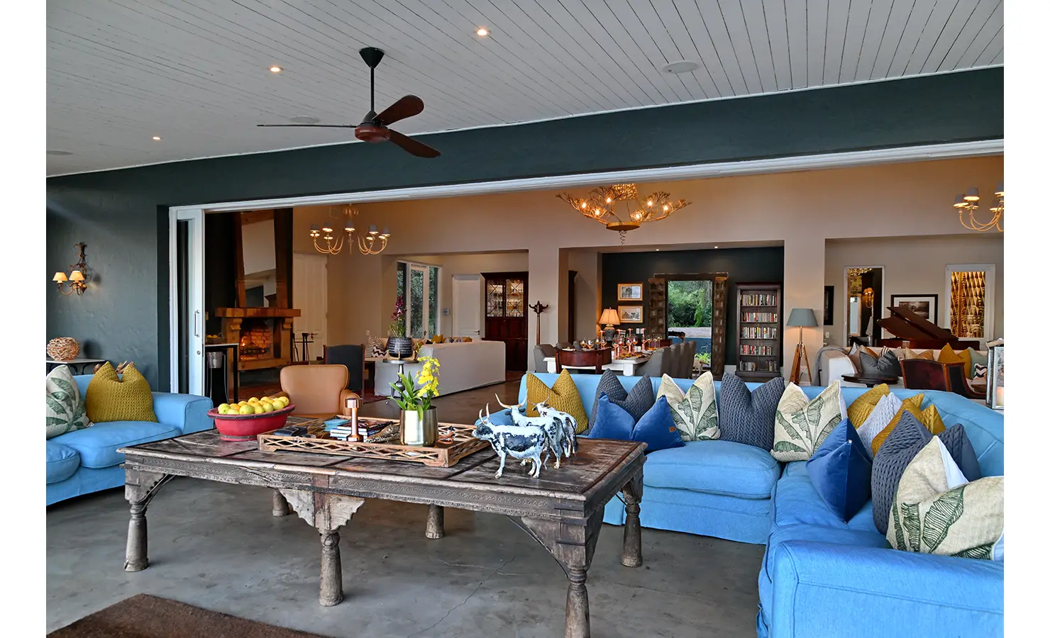Perfect Hideaways: Covered outdoor lounge with blue sofas and decorative cushions, opening directly onto the main dining and living space, Tanyati Villa, Livingstone