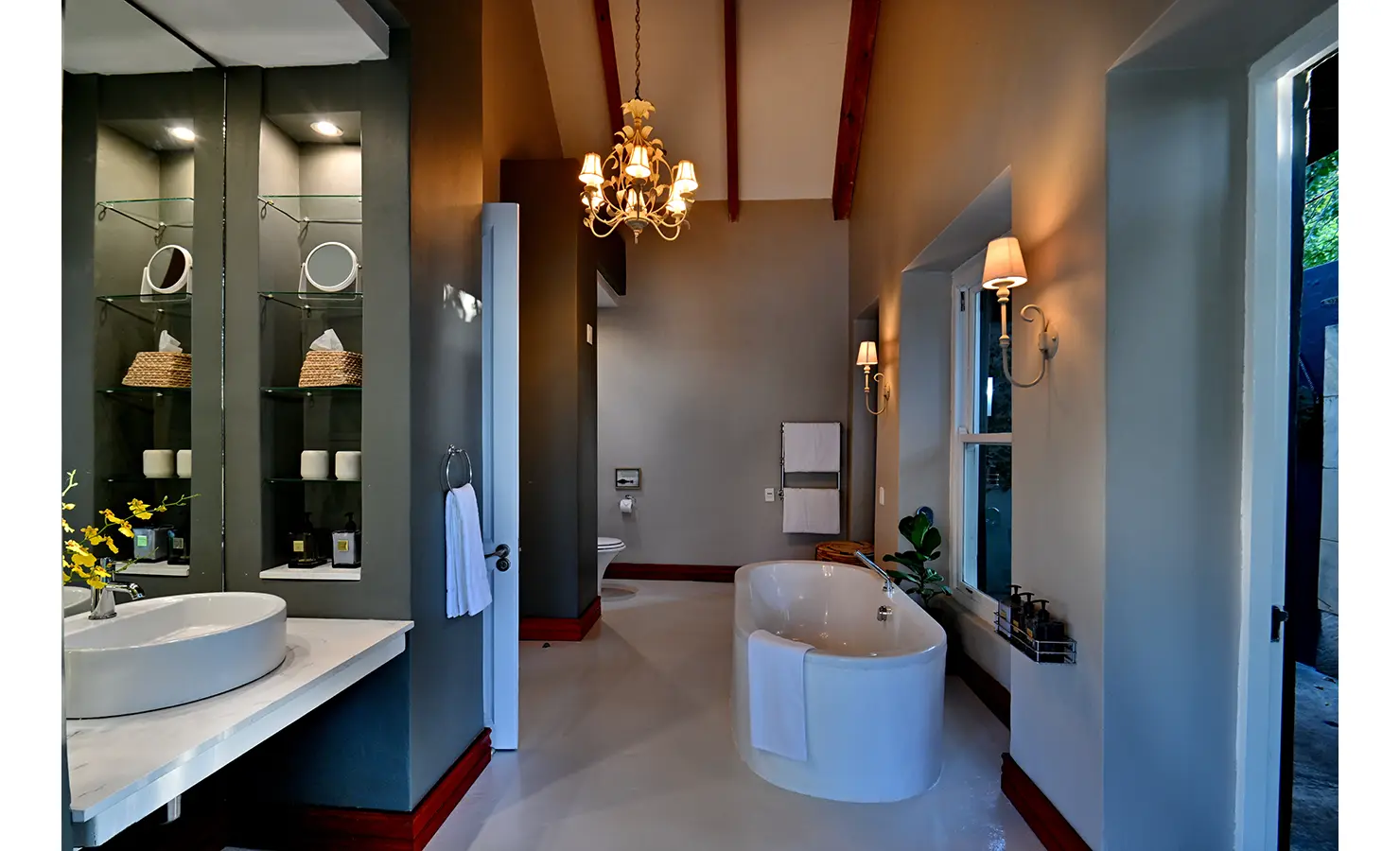 Perfect Hideaways: Spacious bathroom with freestanding bath, wall sconces, and glass shelving under vaulted ceilings, Tanyati Villa, Livingstone