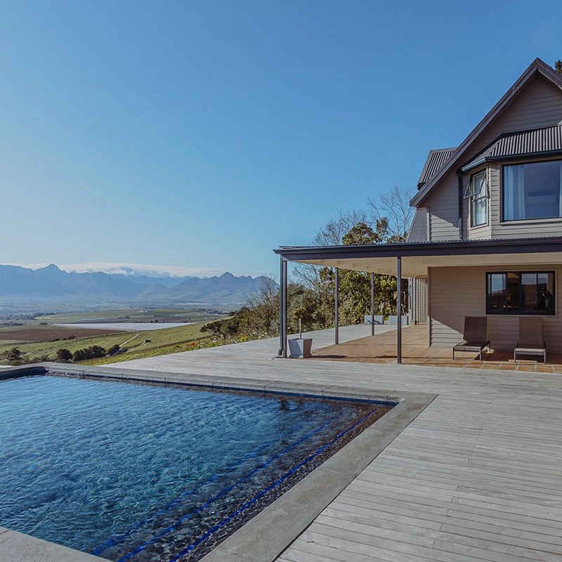 Perfect Hideaways: Pool terrace with timber decking and shaded veranda, panoramic vineyard and mountain views under a clear blue sky, The Villa at Jordan, Stellenbosch