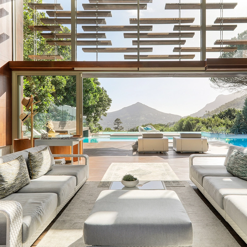 Perfect Hideaways: Double‑volume lounge with sliding glass opens onto the pool terrace, framed by timber louvres and mountain views, Spa House, Hout Bay