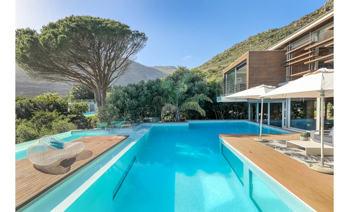 Perfect Hideaways: Contemporary timber‑clad villa with wraparound pool, sun decks and parasols set against lush slopes, Spa House, Hout Bay