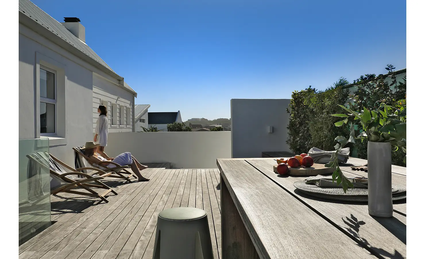 Perfect Hideaways: spacious timber deck with sling loungers and an outdoor dining table, privacy hedges and crisp white walls under cloudless skies, Blanc de Blanc, Yzerfontein