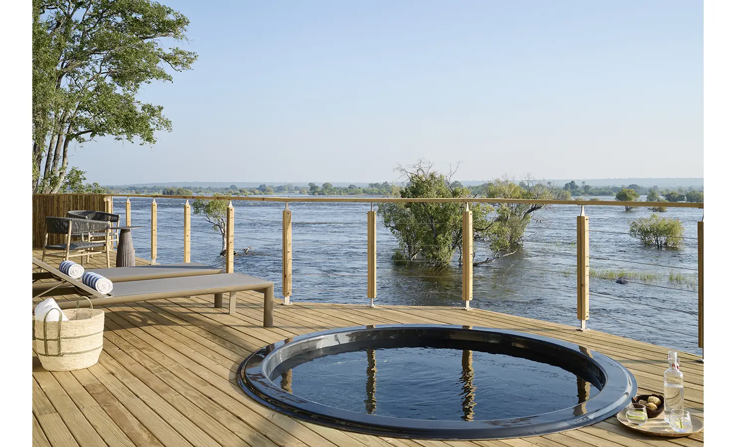 Perfect Hideaways: Circular plunge pool set into a sun deck with sun loungers and uninterrupted river panorama, Rapid's View Villa, Zambezi National Park