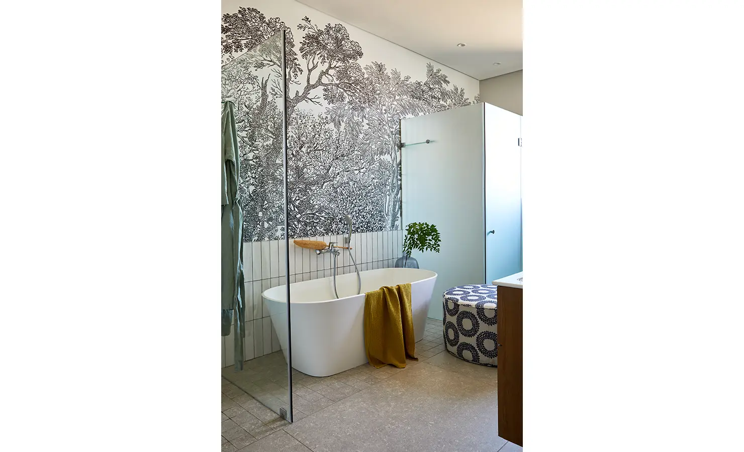 Perfect Hideaways: A serene bathroom features a freestanding tub against a detailed botanical mural, with a mustard towel, patterned ottoman, and frosted glass accents. St Austel, Kenton-on-Sea