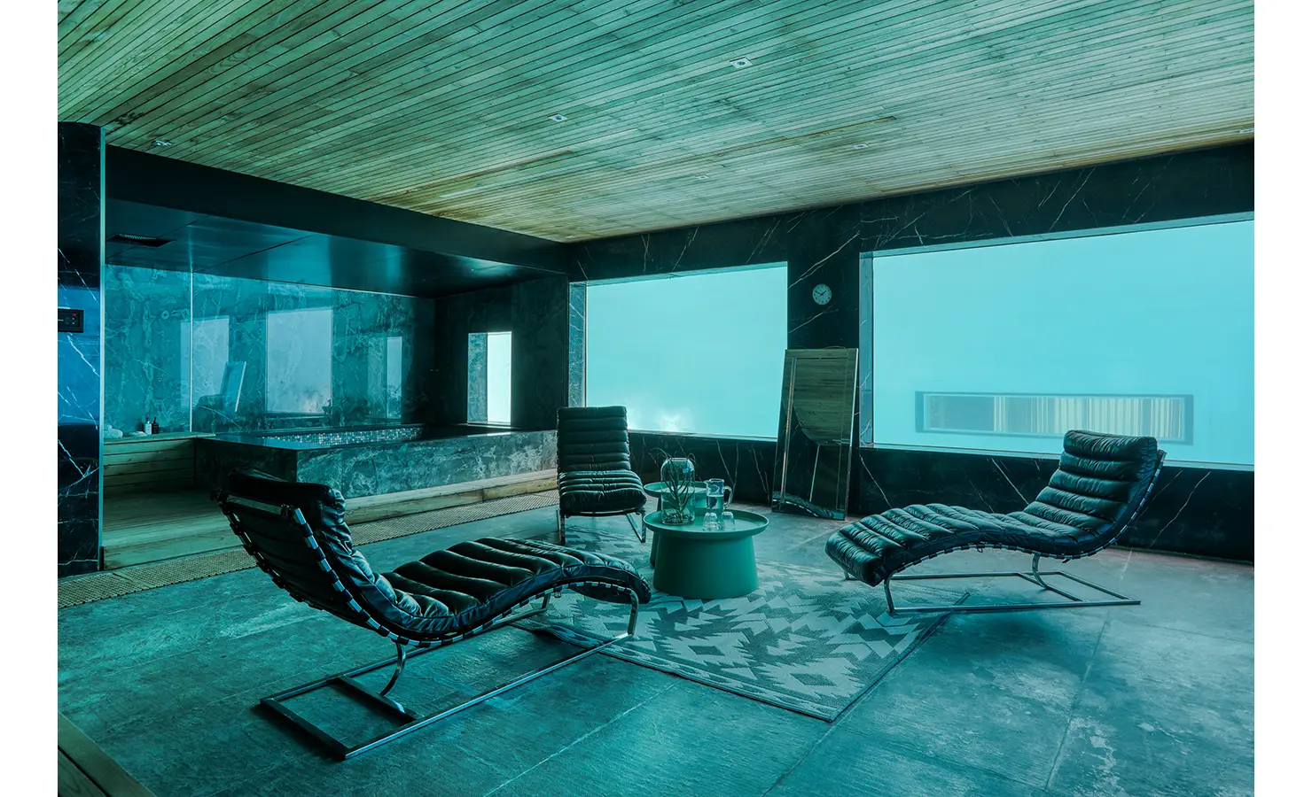 Perfect Hideaways: Subterranean spa lounge with dark marble, cedar ceiling and underwater pool windows beside a hot tub and loungers, Spa House, Hout Bay