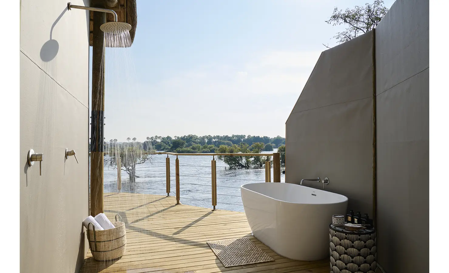 Perfect Hideaways: Outdoor bathroom with rainfall shower and freestanding tub on a private deck overlooking the Zambezi, Rapid's View Villa, Zambezi National Park