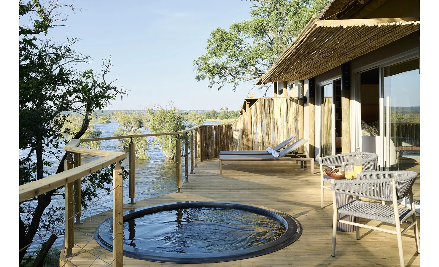 Perfect Hideaways: Private river-facing deck with circular plunge pool, loungers and woven chairs screened by reed fencing, Rapid's View Villa, Zambezi National Park