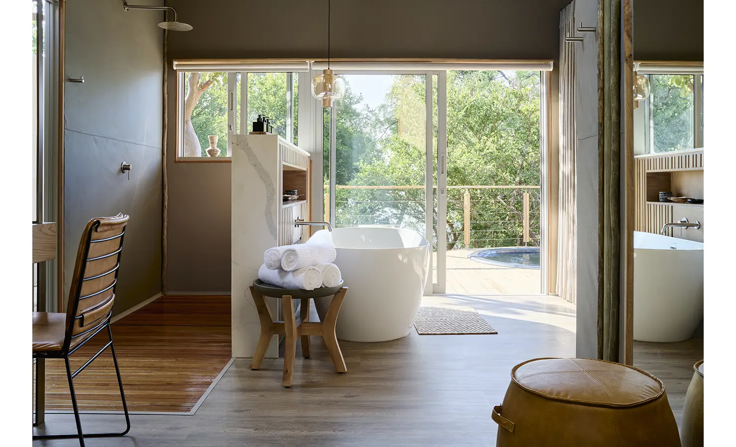 Perfect Hideaways: Light-filled bathroom with freestanding tub, walk-in shower and sliding doors to a deck with plunge pool, Rapid's View Villa, Zambezi National Park