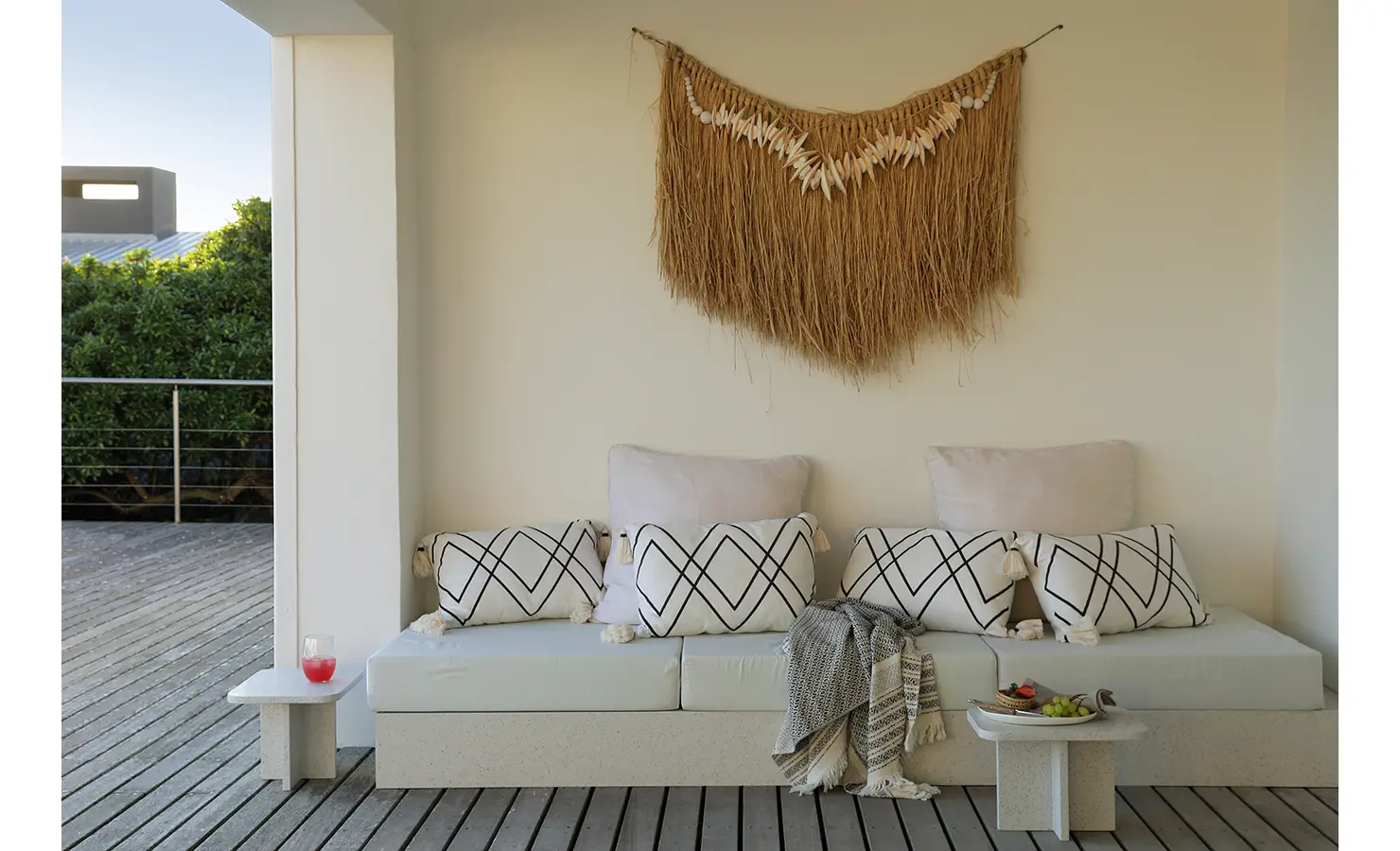 Perfect Hideaways: covered terrace nook with built-in daybed, monochrome patterned cushions and a woven wall hanging, small side tables for sundowners, Blanc de Blanc, Yzerfontein